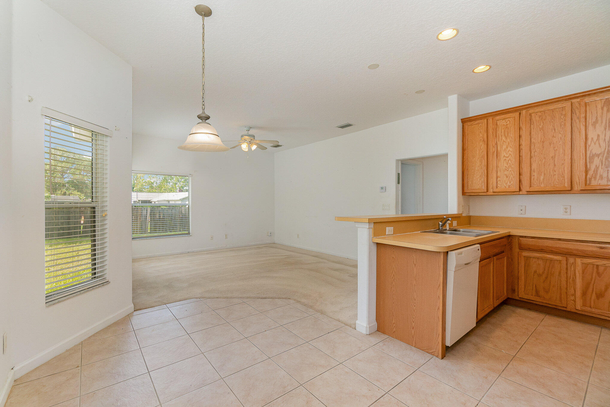 1088 Tupelo Road Southwest Palm Bay, FL 32908 - Photo 10 of 21 a kitchen with stainless steel appliances granite countertop a stove a sink and a refrigerator