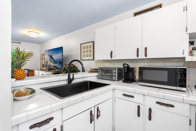 a kitchen with a sink and a microwave