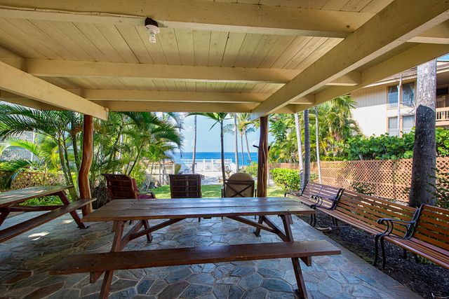 a view of a patio with a table chairs and a backyard