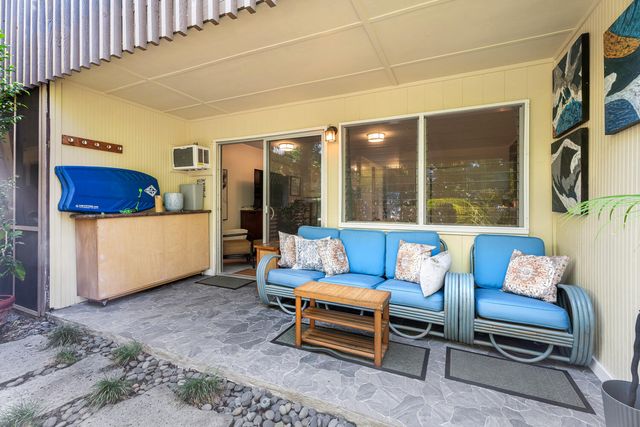 a outdoor space with a couch and a potted plant