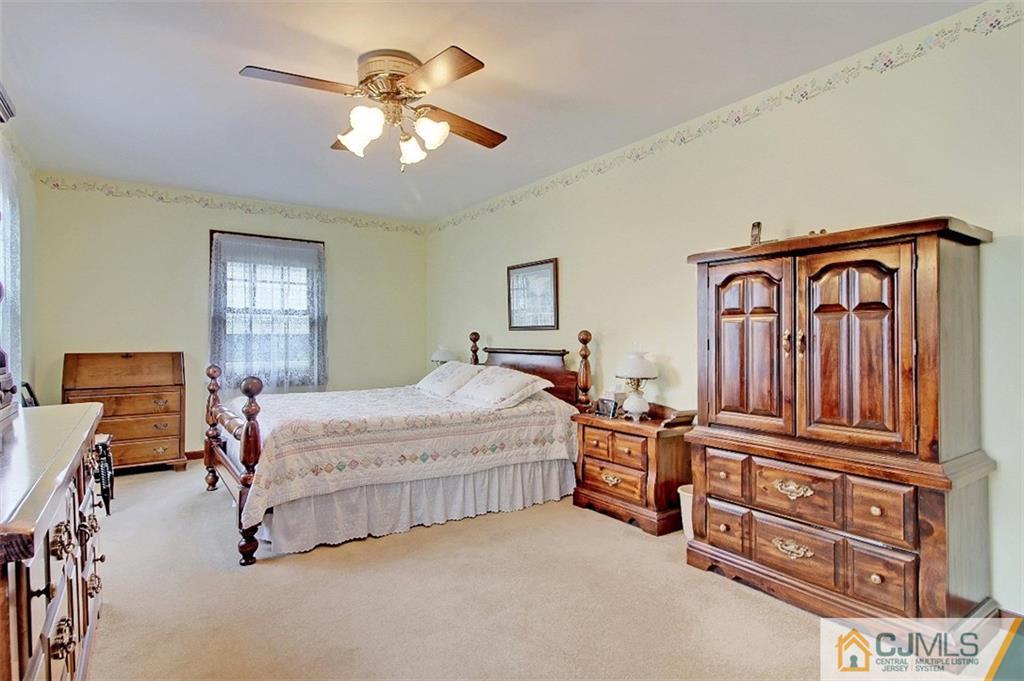 188 Stout Avenue Middlesex, NJ 08846 - Photo 17 of 25 a bedroom with a bed dresser and wooden floor
