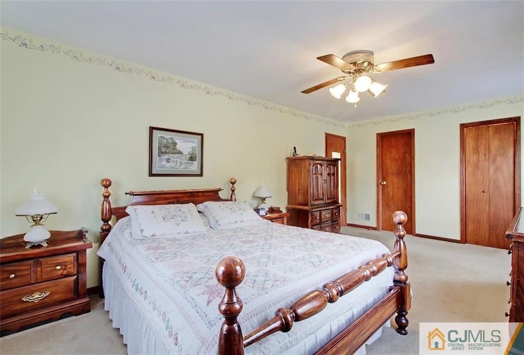 188 Stout Avenue Middlesex, NJ 08846 - Photo 18 of 25 a bed room with a bed and a chandelier