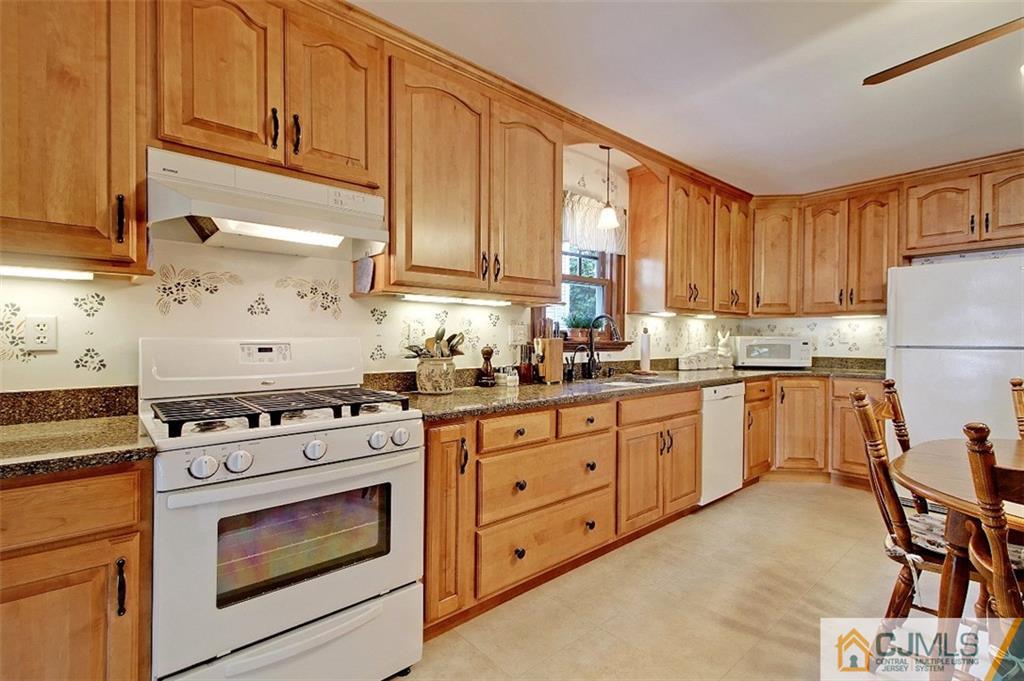 188 Stout Avenue Middlesex, NJ 08846 - Photo 3 of 25 a kitchen with granite countertop white cabinets stainless steel appliances and a window