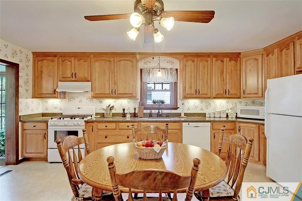 188 Stout Avenue Middlesex, NJ 08846 - Photo 9 of 25 a kitchen with stainless steel appliances granite countertop a stove a refrigerator a kitchen island and chairs