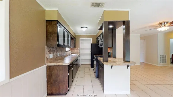 a view of a hallway with furniture and entryway