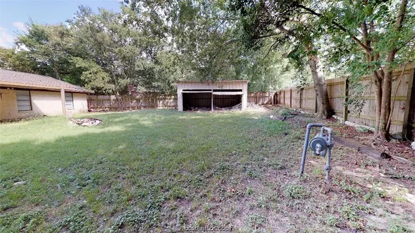 a view of a backyard with a garden and fire pit