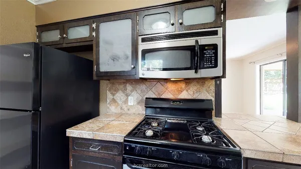 a kitchen with a stove and a microwave
