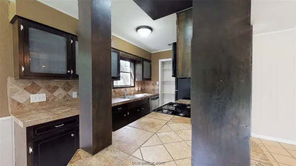 a kitchen with a refrigerator and a stove