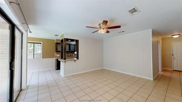 a view of a livingroom with wooden floor and a ceiling fan
