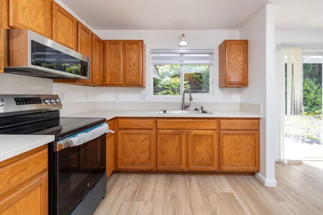 a kitchen with granite countertop a refrigerator and a sink