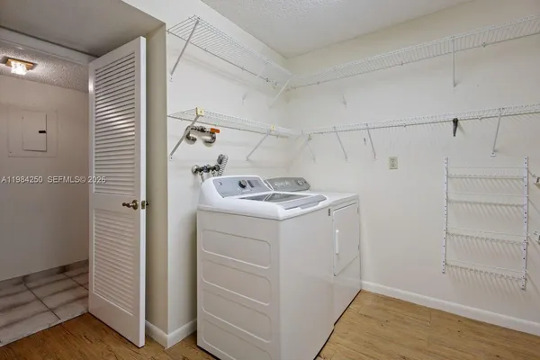 a utility room with cabinets washer and dryer