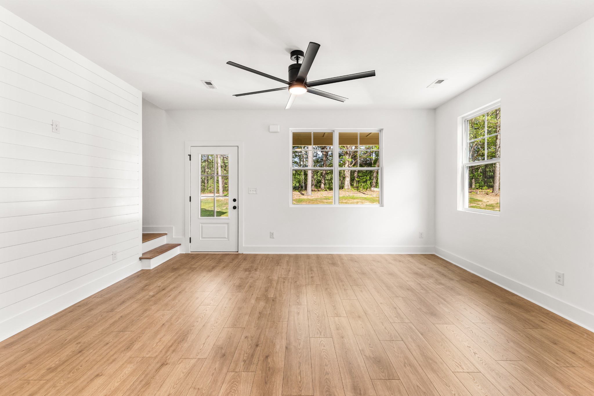 1013 Walnut Grove Road Dickson, TN 37055 - Photo 4 of 38 a view of an empty room with a window and wooden floor