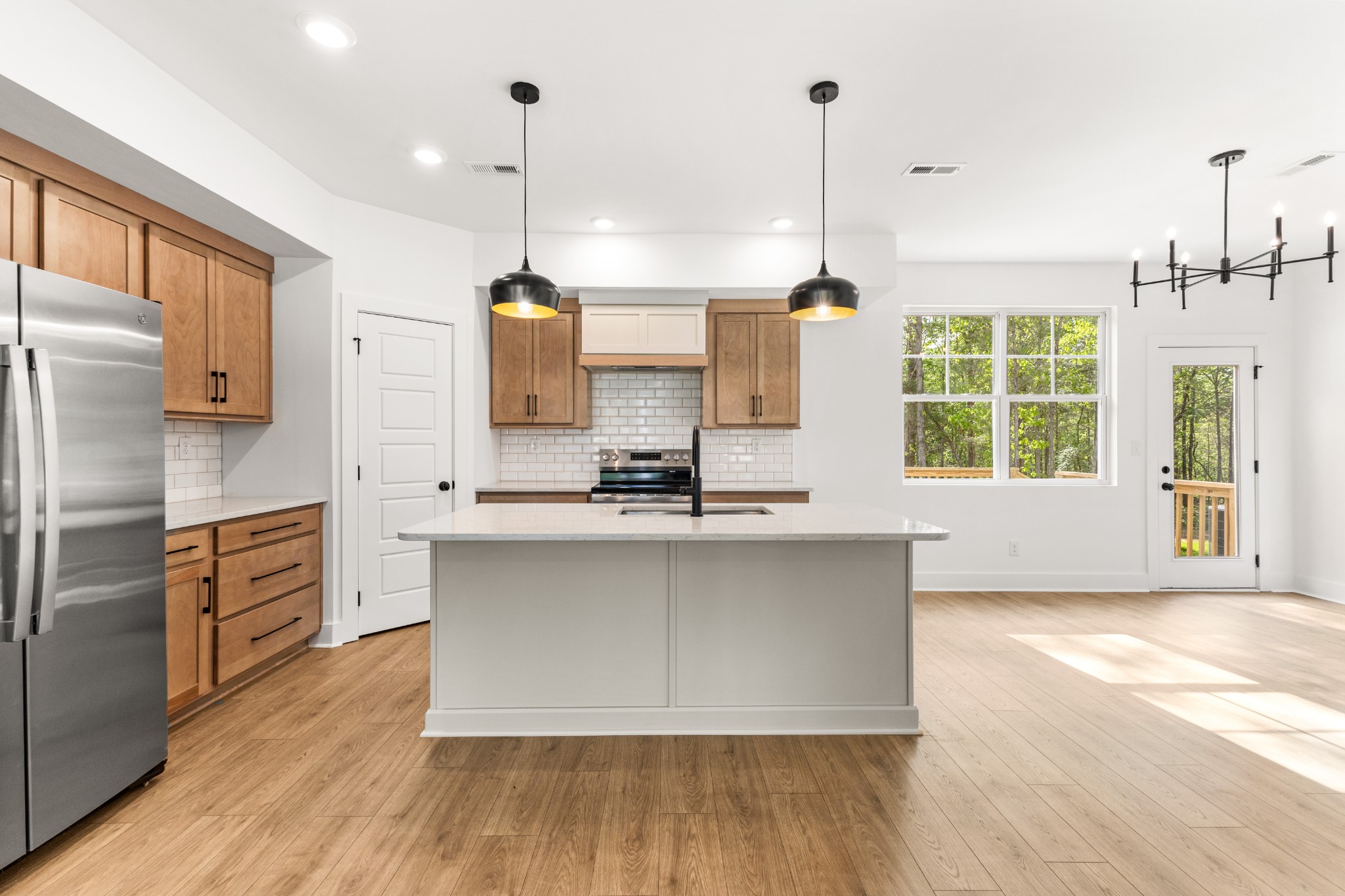 1013 Walnut Grove Road Dickson, TN 37055 - Photo 6 of 38 a large kitchen with kitchen island a large window a sink and stainless steel appliances