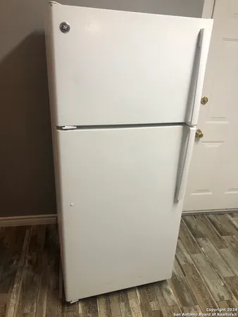 a view of a closet with wooden floor