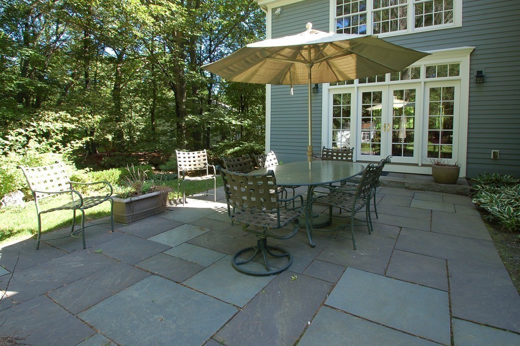 20 Northgate Road Wellesley, MA 02481 - Photo 23 of 24 a view of a patio with table and chairs under an umbrella