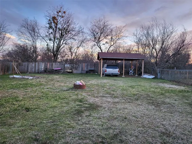 a view of a lake next to a lake with houses in the back