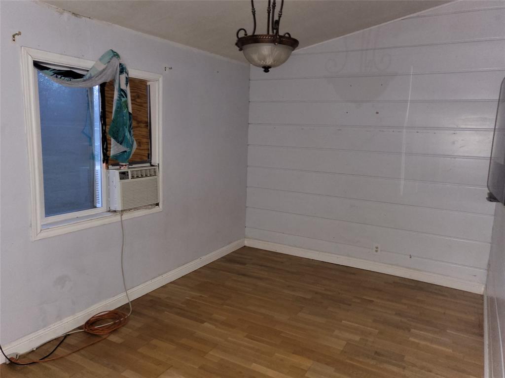 623 West Mesquite Street Jacksboro, TX 76458 - Photo 9 of 25 a view of empty room with wooden floor and fan