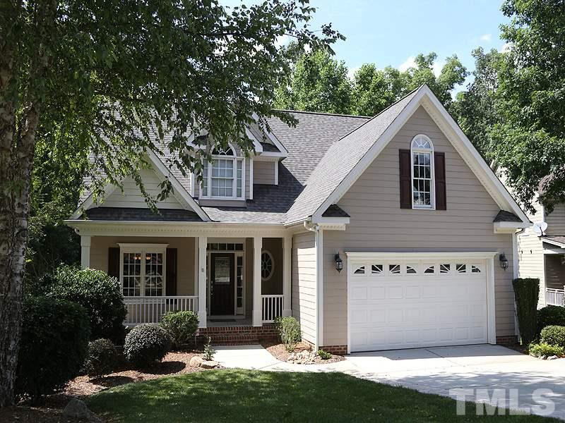 204 Okamato Street Raleigh, NC 27603 - Photo 2 of 25 a front view of a house with a yard and garage