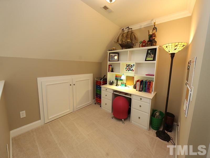 204 Okamato Street Raleigh, NC 27603 - Photo 12 of 25 a storage room with wooden floor and cabinets