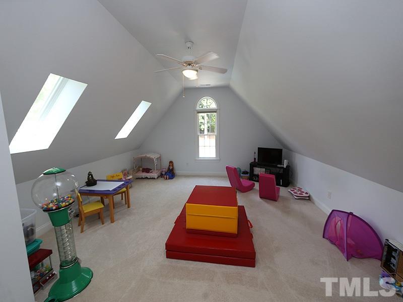 204 Okamato Street Raleigh, NC 27603 - Photo 15 of 25 a living room with furniture a chandelier and a rug