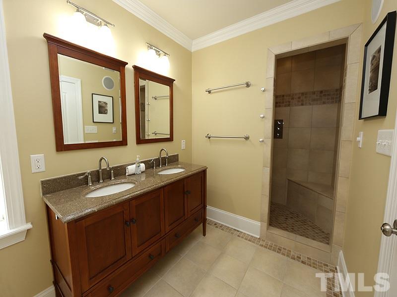204 Okamato Street Raleigh, NC 27603 - Photo 20 of 25 a bathroom with a granite countertop sink mirror and shower