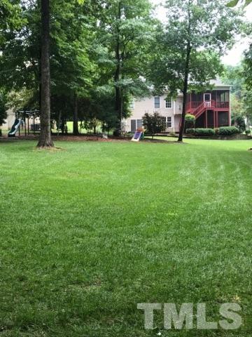 204 Okamato Street Raleigh, NC 27603 - Photo 24 of 25 a view of a yard with plants and large trees