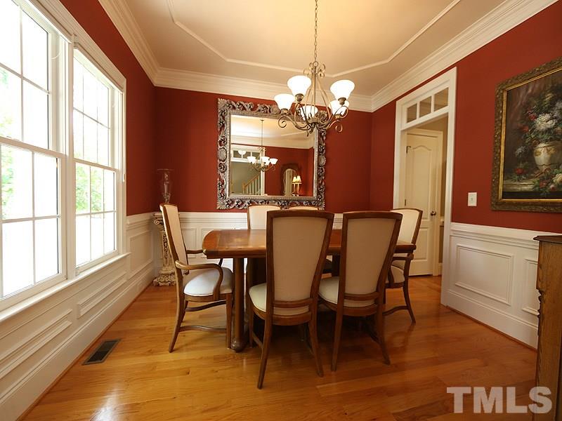 204 Okamato Street Raleigh, NC 27603 - Photo 4 of 25 a view of a dining room with furniture a chandelier and wooden floor