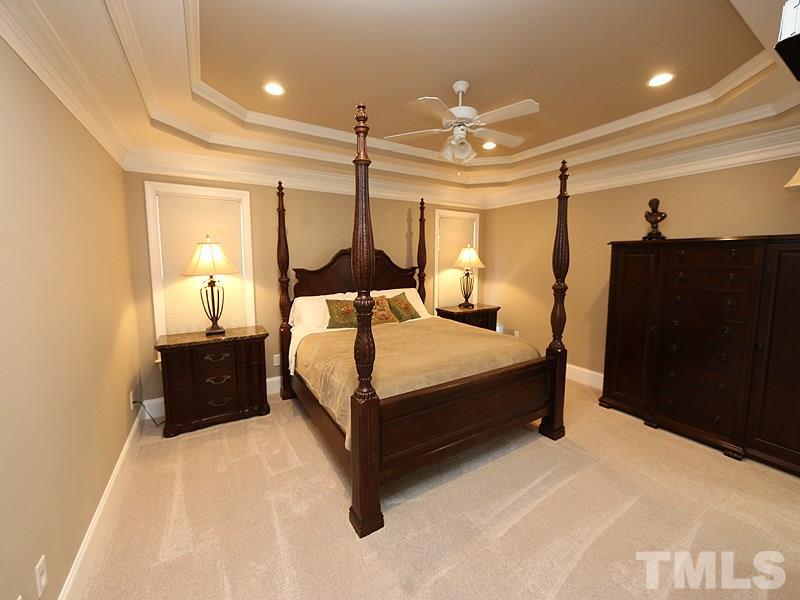 204 Okamato Street Raleigh, NC 27603 - Photo 9 of 25 a bedroom with a bed lamp and a dresser