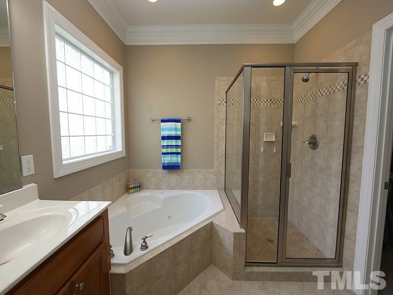204 Okamato Street Raleigh, NC 27603 - Photo 10 of 25 a bathroom with a granite countertop sink a mirror and a bathtub