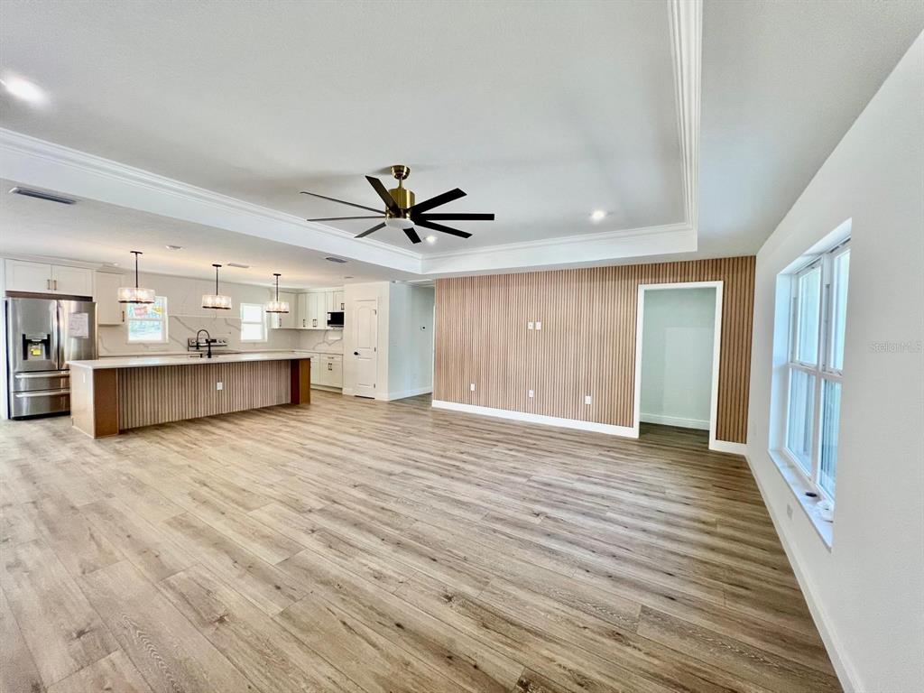 13322 Southwest 66th Street Ocala, FL 34481 - Photo 2 of 15 a view of a livingroom with a hardwood floor and a ceiling fan