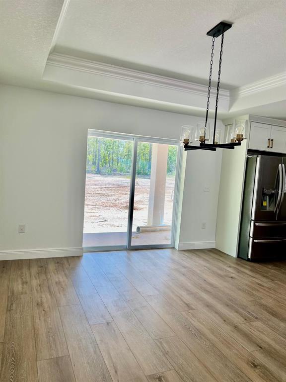 13322 Southwest 66th Street Ocala, FL 34481 - Photo 5 of 15 a view of empty room with wooden floor and fan