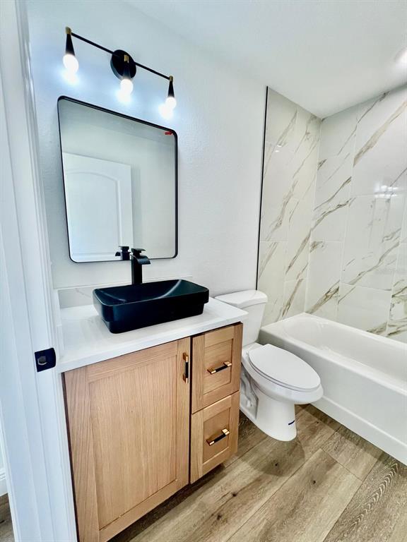 13322 Southwest 66th Street Ocala, FL 34481 - Photo 10 of 15 a bathroom with a toilet a sink and a mirror