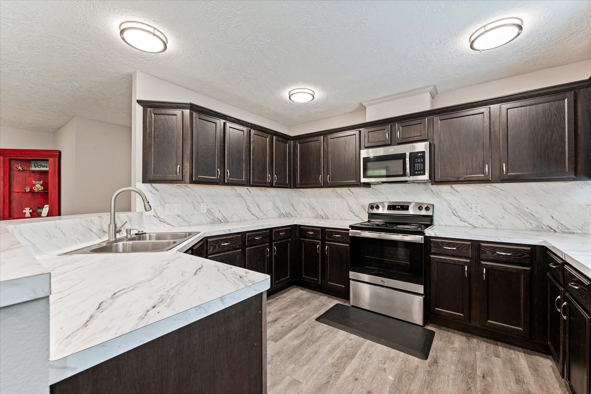 3998 Frontier Road Willis, TX 77378 - Photo 21 of 33 a kitchen with stainless steel appliances granite countertop a sink stove microwave and cabinets