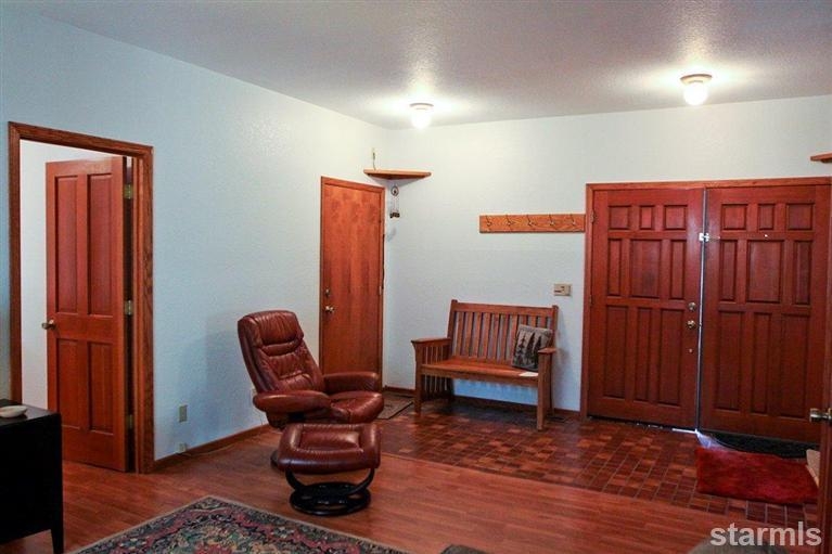 272 Chimney Rock Road Stateline, NV 89449 - Photo 5 of 35 a living room with furniture a wooden floor and a chair