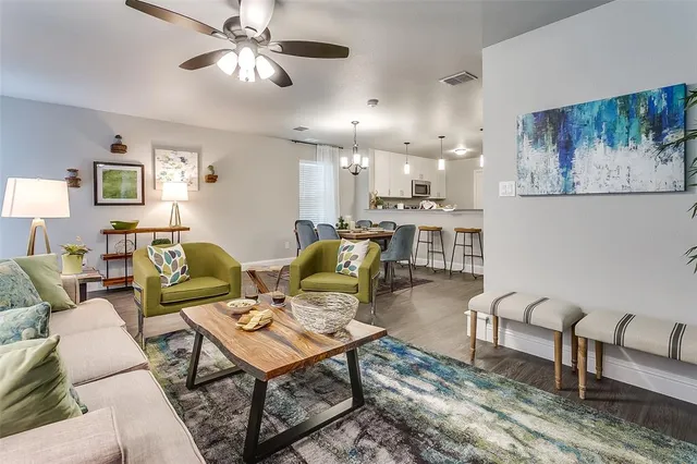 a living room with furniture and a chandelier
