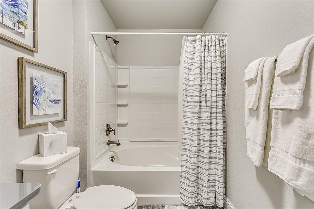 3816 Sheraton Road Denton, TX 76209 - Photo 35 of 40 a bathroom with a toilet and a shower