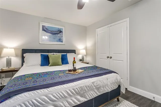 a bedroom with a bed and painting on the wall