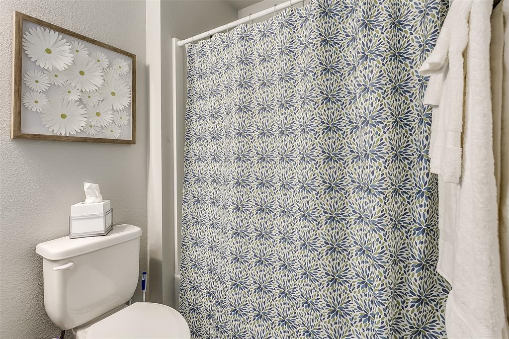 3816 Sheraton Road Denton, TX 76209 - Photo 40 of 40 a white toilet sitting next to a shower curtain