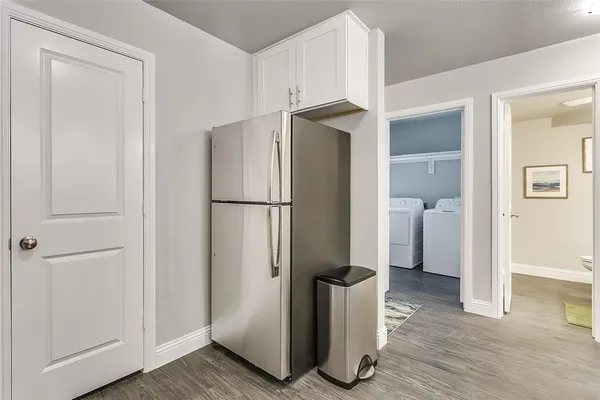 a view of a bathroom with a sink and a refrigerator