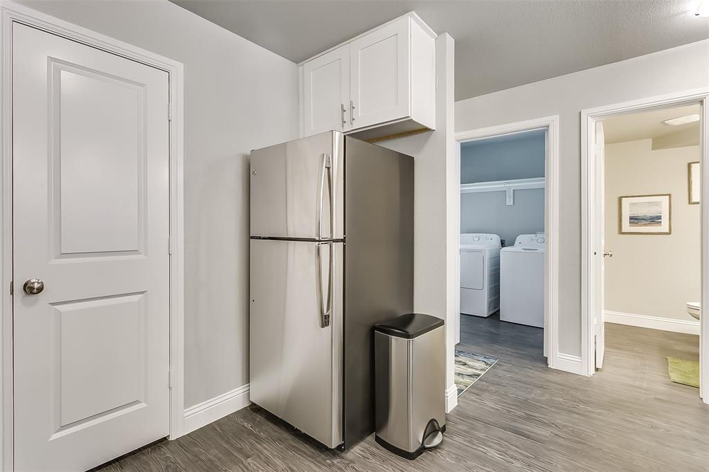 3816 Sheraton Road Denton, TX 76209 - Photo 7 of 40 a view of a bathroom with a sink and a refrigerator