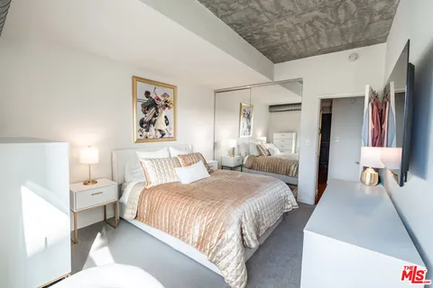 a bedroom with a bed and a couch