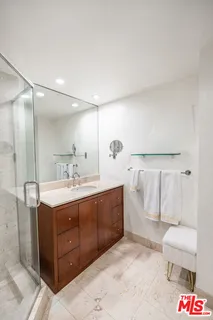a spacious bathroom with a bathtub sink mirror and toilet