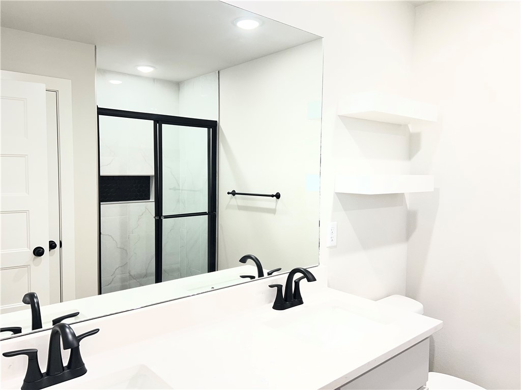 1715 Cuppett Circle Pea Ridge, AR 72751 - Photo 12 of 15 Double vanity with matte black faucets, large frameless mirror, and recessed lighting