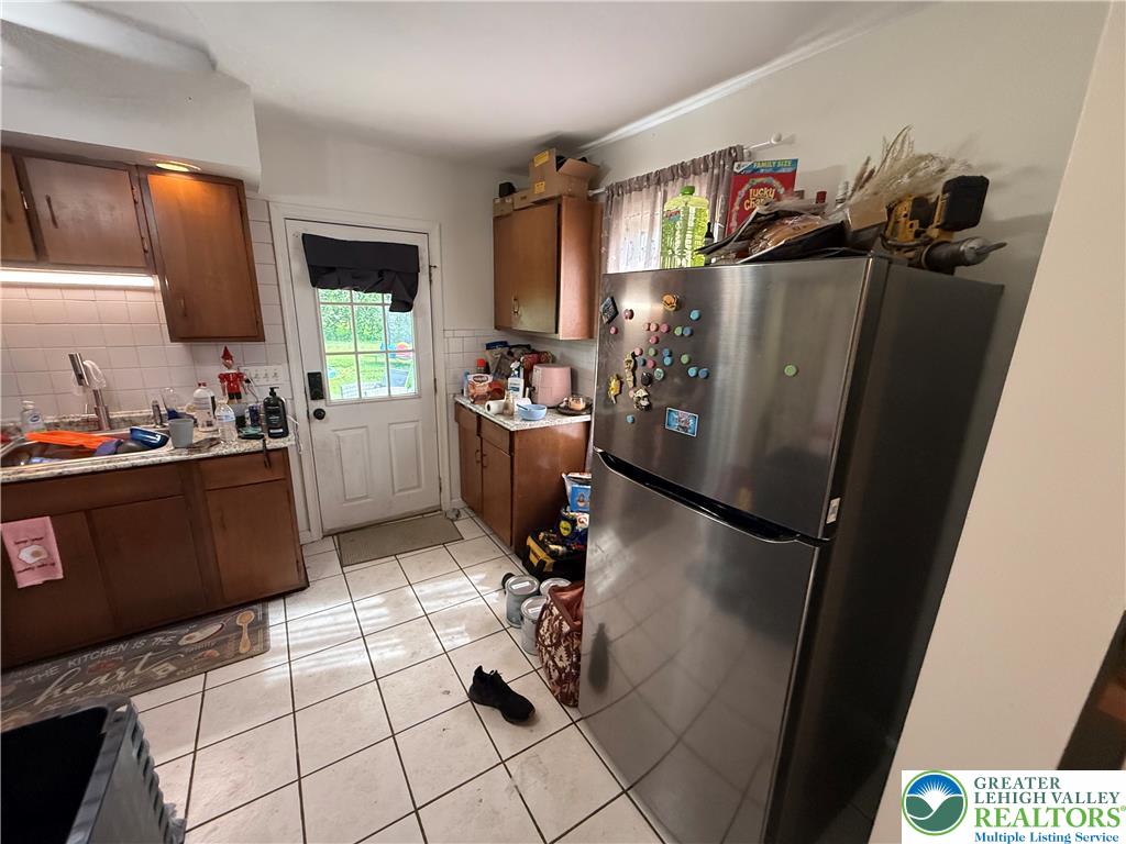 2955 Middletown Road Bethlehem, PA 18020 - Photo 9 of 20 A compact kitchen featuring practical tile flooring and an outdoor access door.
