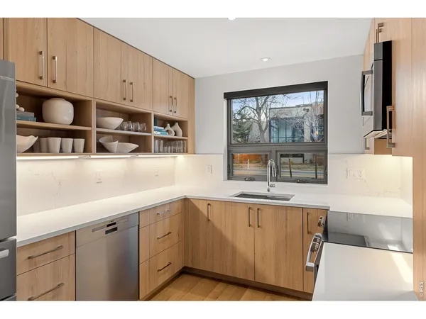 a kitchen with stainless steel appliances a refrigerator and a sink