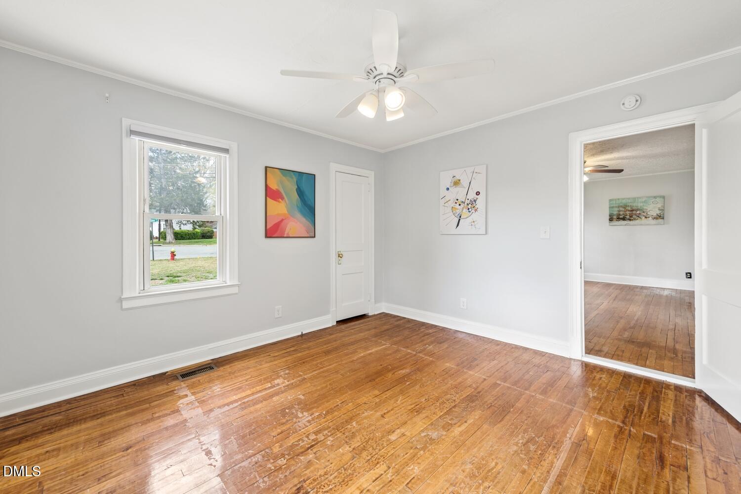 414 South Maple Street Graham, NC 27253 - Photo 21 of 42 a view of an empty room with wooden floor and a window