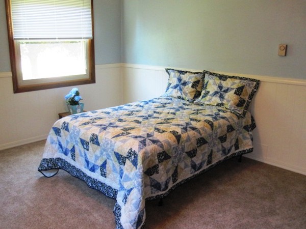 294 Southampton Road Westhampton, MA 01027 - Photo 13 of 26 a bed sitting in a bedroom next to a window