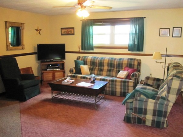 294 Southampton Road Westhampton, MA 01027 - Photo 18 of 26 a living room with furniture and a flat screen tv