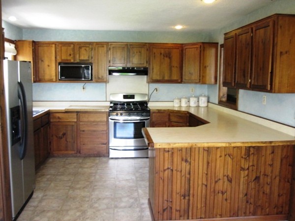 294 Southampton Road Westhampton, MA 01027 - Photo 6 of 26 a kitchen with kitchen island granite countertop wooden cabinets a stove top oven a sink and dishwasher