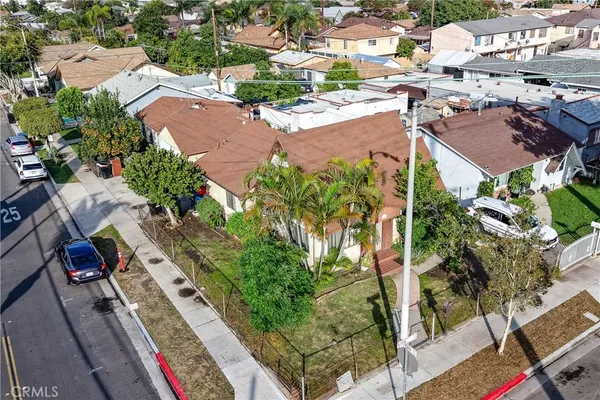 an aerial view of residential houses with yard